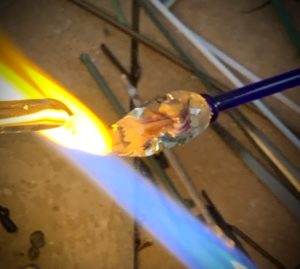 Glass is melted with a blowtorch